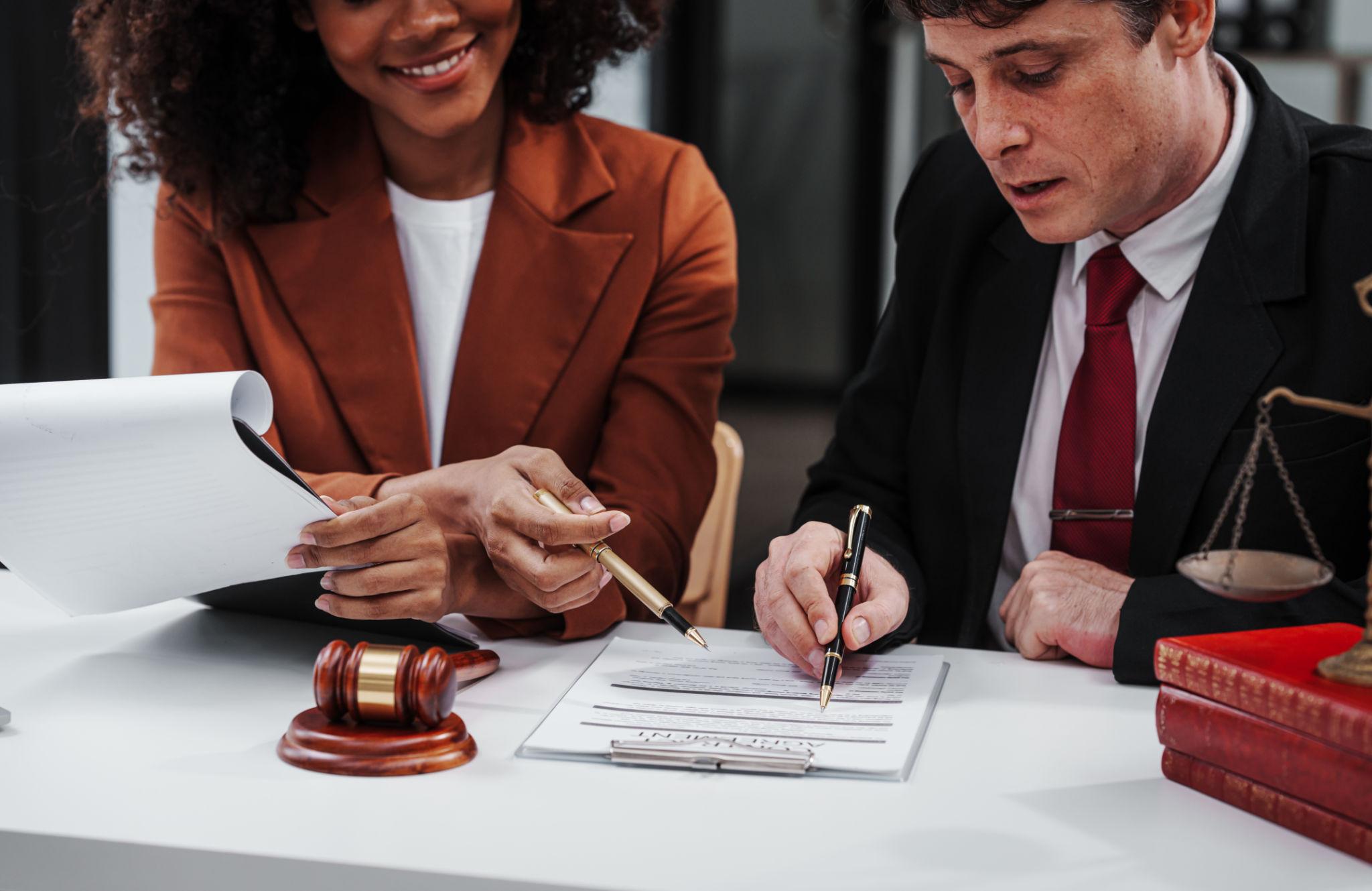 Lawyers signing legal documents with organized workflow supported by law firm technology systems