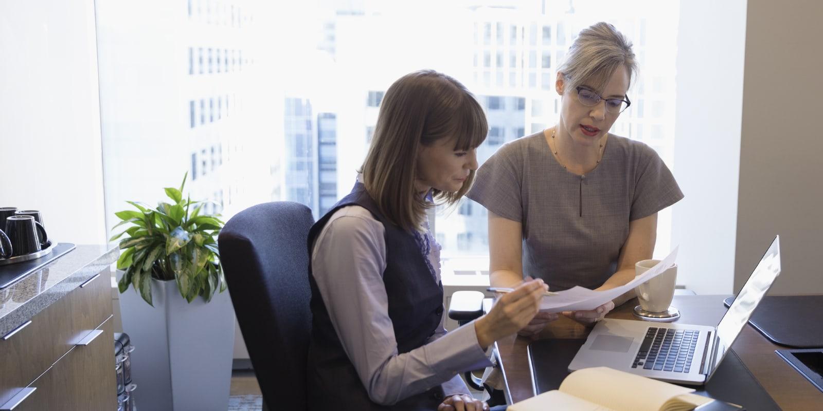 Attorneys reviewing documents together using efficient technology to support billable work in a law firm